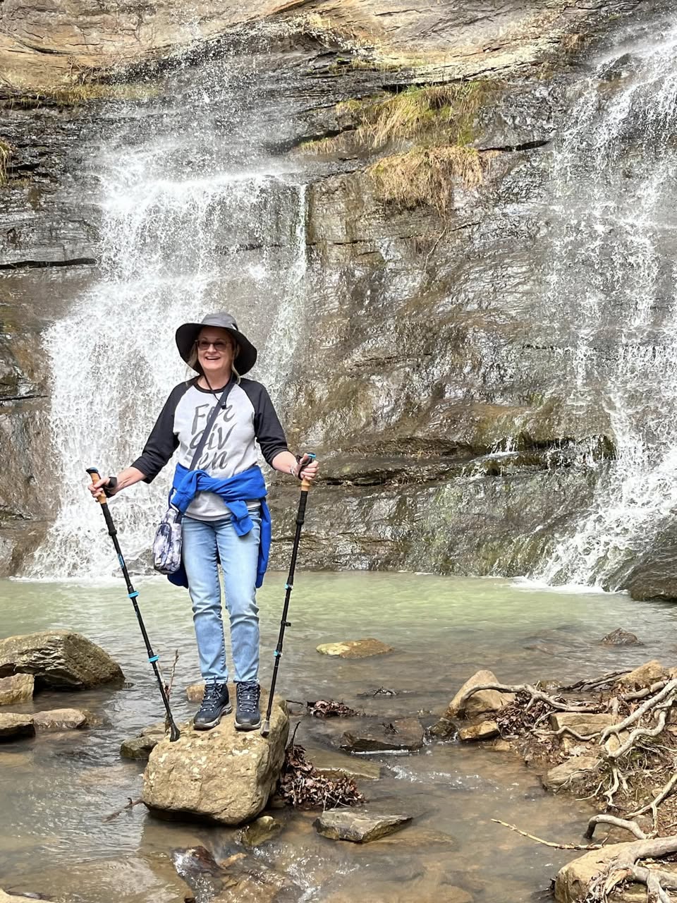 Travel Helper using trekking poles on an excursion